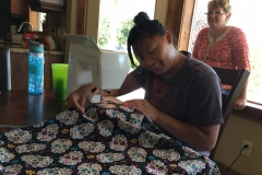 Student learning to sew