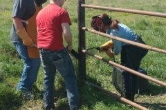 Students welding with mentors